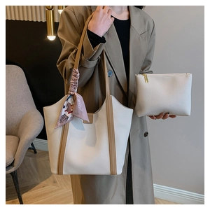 Two-piece set with cream lychee leather tote bag and scarf detail in a home setting