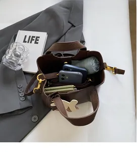 Detail view of the spacious inner compartments of the brown leather bucket bag