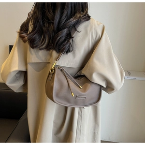 Detail of dark brown litchi pattern leather Hobo bag with adjustable strap and tassel