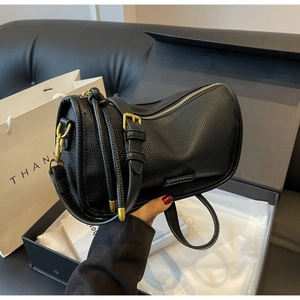 Close-up of black lychee texture leather Boston bag with premium gold-tone hardware