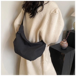 Model shot of a large black crescent hobo bag made of durable nylon for daily use