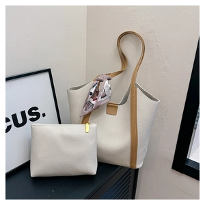 Detail of off-white lychee pattern tote bag with matching pouch and printed silk scarf