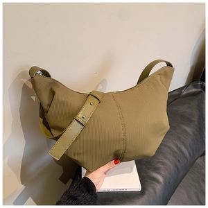 Detail of olive hobo bag showing corduroy texture and metallic rivet accents