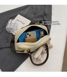 Interior view of the two-tone Boston bag showing large capacity for phone and wallet