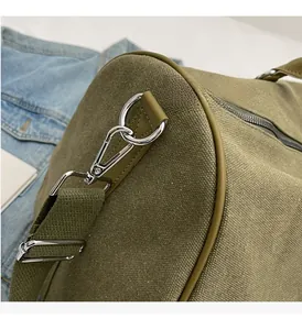 Close-up of high-quality silver metal hardware and reinforced canvas strap on travel bag