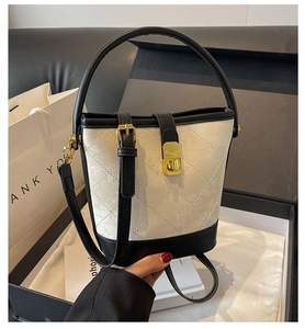 Detailed shot of retro bucket bag with diamond lattice pattern and gold metal hardware