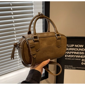 Detail of vintage matte crossbody bag showing premium stitching and material textures