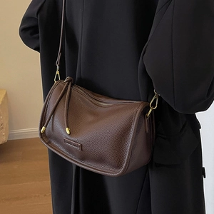 Deep brown Boston bag in lychee pattern leather with stylish tassels and shoulder strap