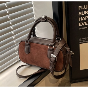 Detail of Boston-style brown leather and suede panel handbag with adjustable strap