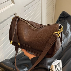 Large dark brown pebble leather Boston bag with gold hardware and shoulder strap