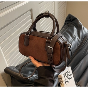 Detail of dark brown suede and leather Boston bag with silver hardware and adjustable strap