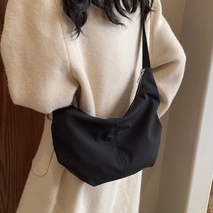 Large black textured hobo bag with silver zipper for women, minimalist vintage style