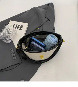 Internal view of a quilted white bucket bag showing large capacity for phones and umbrella