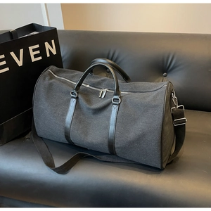 Top view of large canvas travel bag with leather handles and adjustable shoulder strap