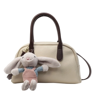 Cream vintage Boston handbag with brown handles and a cute bunny plush charm