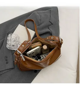 Detailed view of the spacious interior of a brown vintage leather shoulder bag for women
