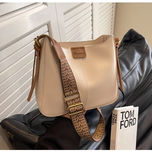 Detail of cream PU leather crossbody bag with ethnic style woven wide shoulder strap