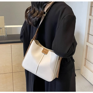 Detail of white leather hobo bag with vintage geometric jacquard wide shoulder strap
