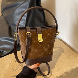 Vintage quilted bucket bag with brown patchwork leather and gold twist lock closure