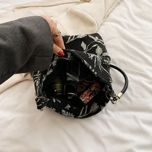 Detail showing the spacious interior of a floral canvas bucket bag with daily cosmetics