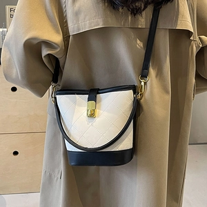 Retro black and white quilted bucket bag with gold lock and black shoulder strap