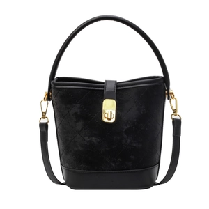 Chic black quilted velvet bucket bag with gold hardware and leather shoulder strap
