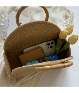 Top view of spacious woven straw handbag interior showing ample storage for daily essentials