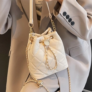 Quilted cream chain bucket bag for women, elegant crossbody style for daily wear