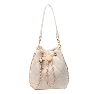 Quilted cream bucket bag with gold chain strap and drawstring closure on white background