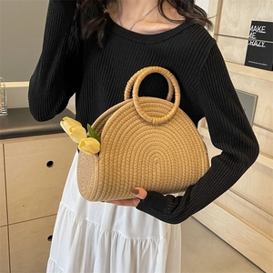 Handcrafted semicircular straw tote bag with round handles and natural woven texture