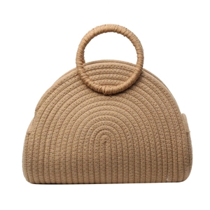 Handmade straw basket bag with circular handles in a classic semi-circular beach design