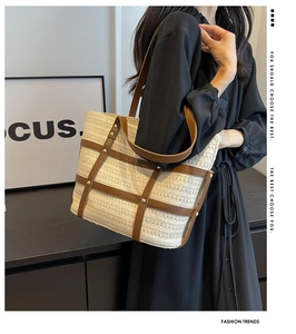 Modern woven tote bag with brown leather straps shown on a model in a minimalist setting