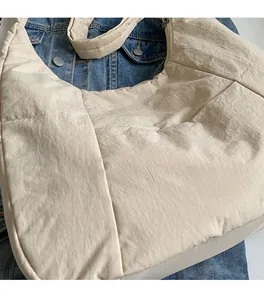 Detail of soft quilted nylon tote bag with high-quality stitching and padded texture