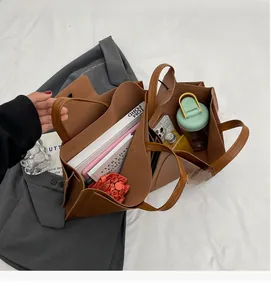 Top-down view of a brown tote bag showcasing large capacity for books and daily essentials