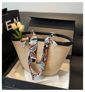 Detail of straw tote bag with geometric silk scarf and wood bead handle in gift box