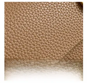 Vista macro della pelle marrone caramello con venatura uniforme a litchi della borsa