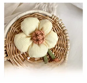 Detailed macro view of woven straw bag with fabric flower decor and pearl accessories