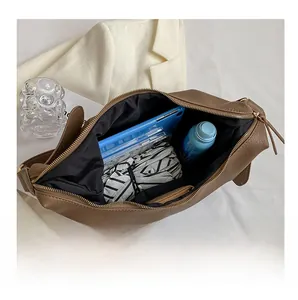 Top view of large capacity coffee hobo bag with gold zipper and daily essentials inside