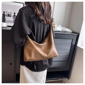 Rear view of brown lychee leather hobo bag showing large capacity and minimalist design