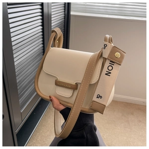 Detailed shot of leather crossbody bag with metal magnetic buckle and dual strap options