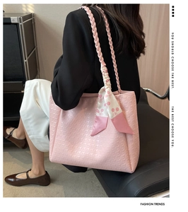 Detail of light pink tote bag featuring houndstooth texture and cherry print silk scarf