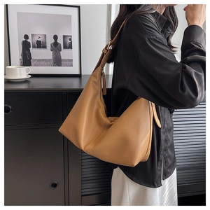 Brown lychee texture Hobo bag shown on shoulder, highlighting capacity and drape