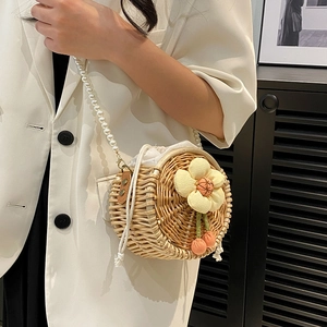 Handmade round straw crossbody bag with floral cherry charms and pearl shoulder strap