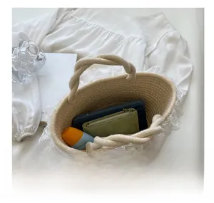 Top view of beige woven tote bag interior showing capacity for phone and cosmetics