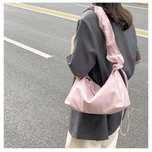Detailed view of pink pleated shoulder bag with soft leather texture and ruffles