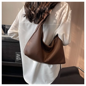 Detail of dark brown lychee grain leather hobo bag showing texture and slouchy design