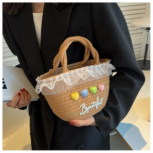 Macro detail of hand-woven straw tote bag with lace edge and colorful heart charms
