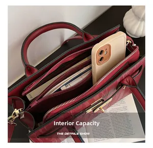 Internal capacity detail of red patent leather handbag showing multi-layer compartments