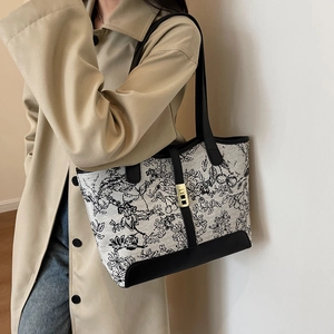 Large tote bag with vintage floral print and black leather straps for daily commute