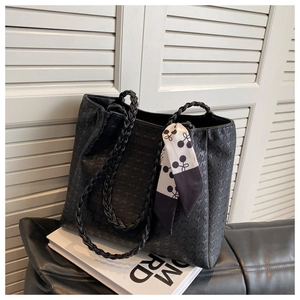 Detail of black houndstooth embossed tote bag with a geometric pattern silk scarf